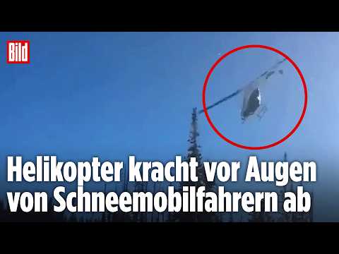 HORROR-ABSTURZ IN DEN USA: Helikopter kracht vor Schneemobil-Fahrern ins Gelände